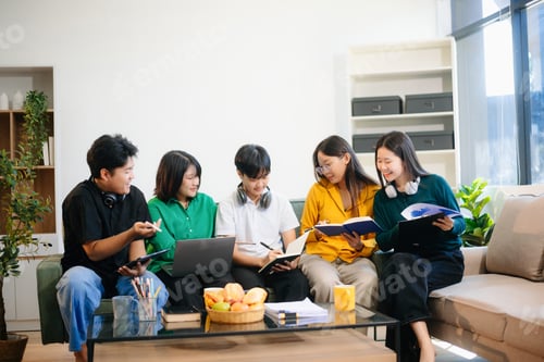 Preview: Young Asian students working on a project with laptops and tablets. Cozy indoor setting, teamwork,