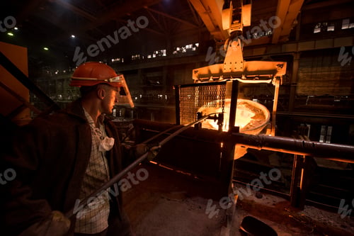Preview: Steelworker at work near the tanks with hot metal
