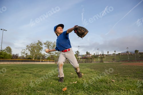 Preview: Boy throwing ball at practise on baseball field
