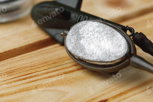 Preview: Lead sinker on wooden background macro shot