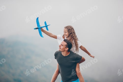 Preview: Beautiful happy family in mountains in the background of fog