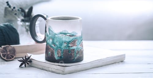 Preview: book and a cup of tea on a wooden background