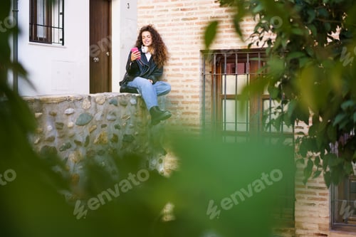 Preview: A Young Woman Delightfully Enjoying a Refreshing Drink Outdoors in an Urban Setting