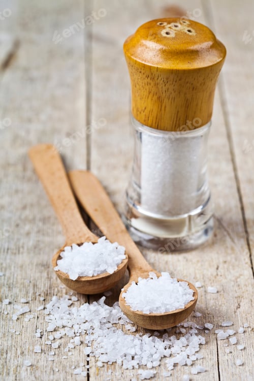 Preview: Wooden spoon with sea salt and cellar closeup on wooden rustic table.