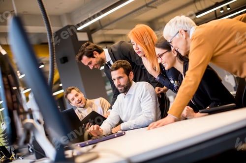 Preview: Senior businesswoman working together with young business people in office