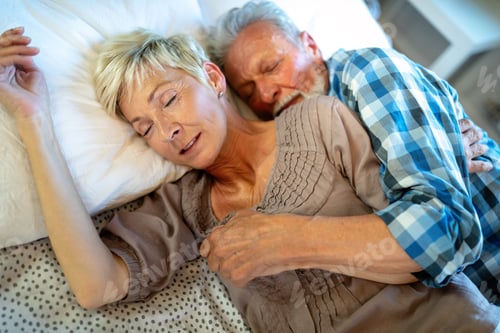 Preview: Happy senior couple embracing, sleeping together in bedroom