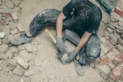Preview: A young man cleans bricks with an axe.