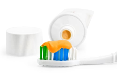 Preview: Toothbrush with orange toothpaste