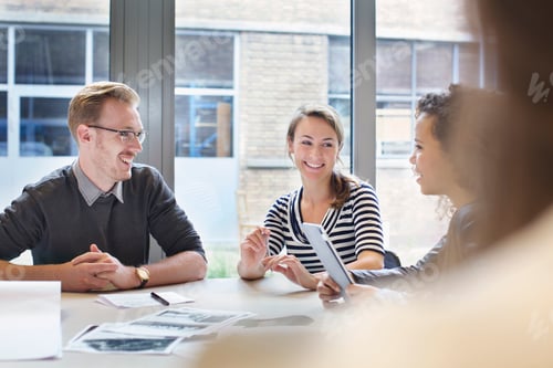 Preview: Design team meeting at conference table in creative office