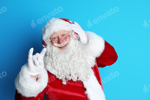 Preview: Authentic Santa Claus listening to music on color background