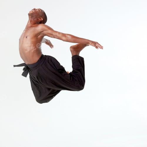 Preview: Graceful dancer in midair leap against a neutral background.