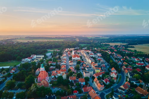 Preview: Suburban landscape with small town at sunrise
