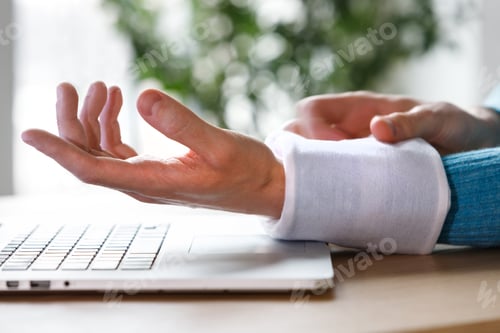 Preview: man applying cold compress to a his painful wrist