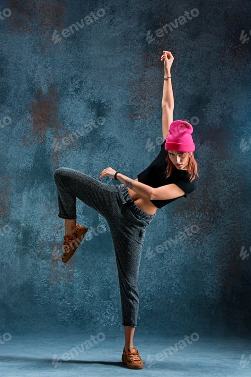 Preview: Young girl break dancing on wall background.