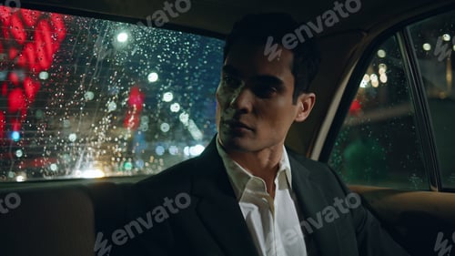 Preview: Car passenger resting vehicle at evening closeup. Model guy looking rain window