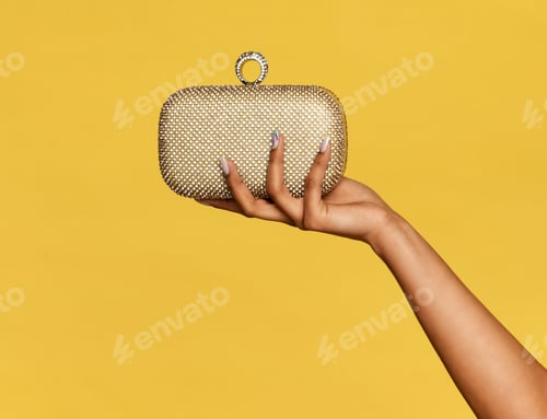 Preview: Young black woman holding a stylish gold metallic pochette