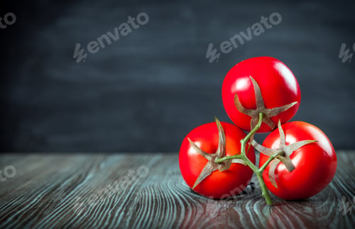 Preview: Tomatoes on wooden table dark background copy space