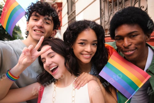 Preview: Young activists taking selfie showing rainbow flags celebrating gay pride