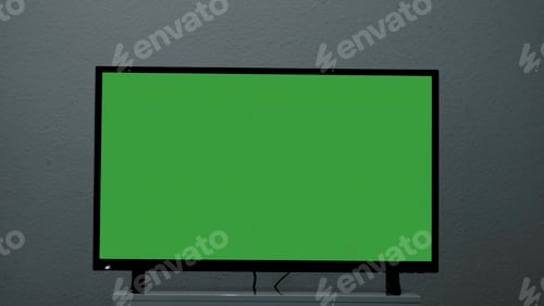 Preview: Plasma TV with green screen stands on background wall. Concept. Green-screen TV stands on background