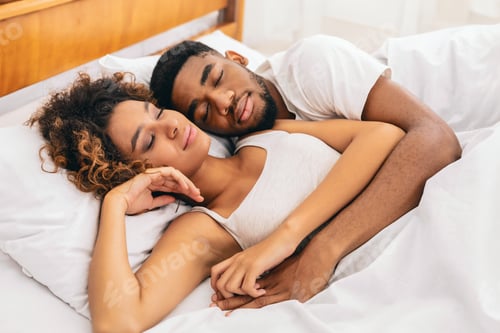 Preview: Couple in a tender embrace on white sheets