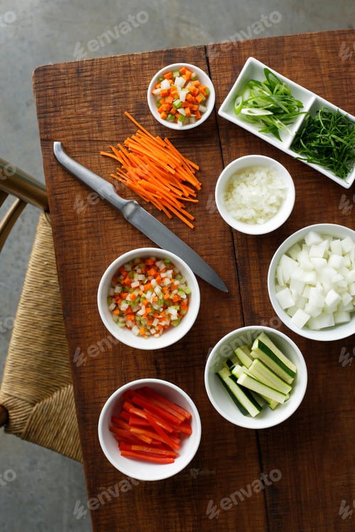 Preview: Bowls of chopped vegetables on table