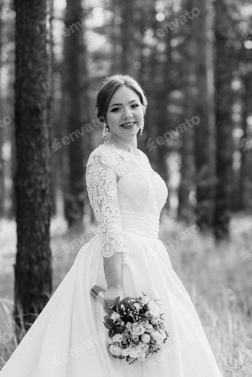Preview: the bride walking in a pine forest