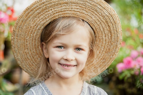 Preview: Toddler with flower basket. girl holding pink flowers