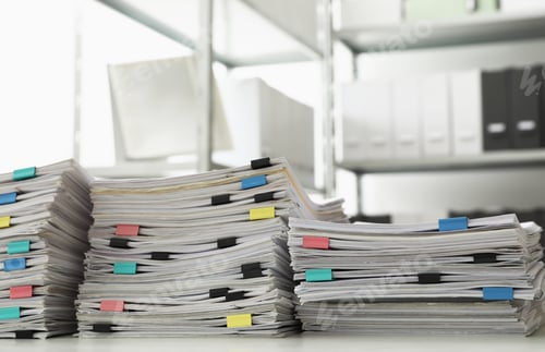 Preview: Stacks of documents with paper clips on office desk
