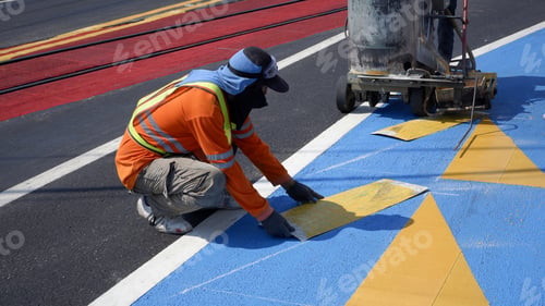 Preview: Road workers with thermoplastic marking machine paint traffic sign and bicycle lane on asphalt road