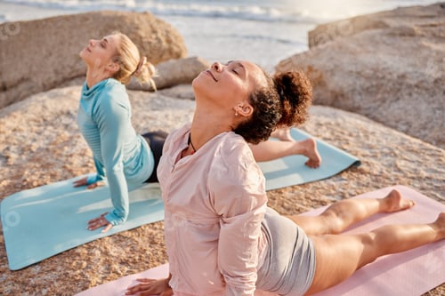 Preview: Yoga, relax and woman friends meditating on the beach together for mental health or wellness during