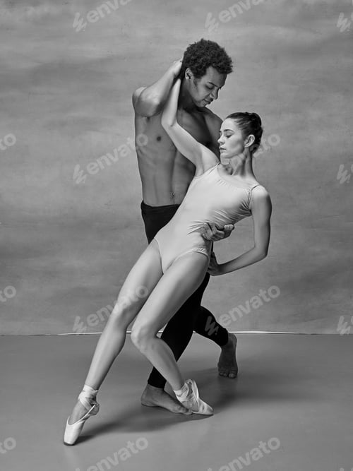 Preview: Couple of ballet dancers posing over gray background
