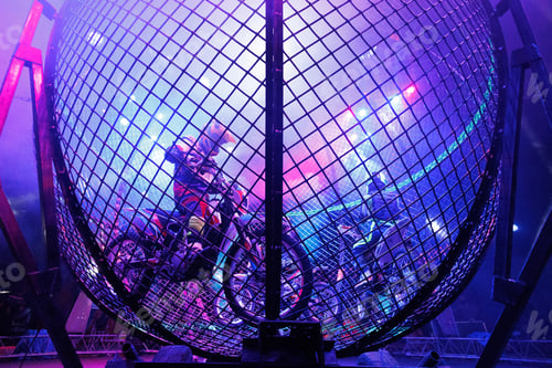 Preview: Dangerous show involving motorcyclists in circus. Stuntmen ride motorcycles in metal round cage.