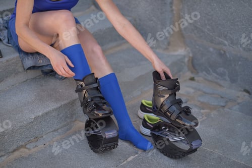 Preview: Fit legs in kangoo jumping shoes. womanpreparing for Kangoo Jumping training