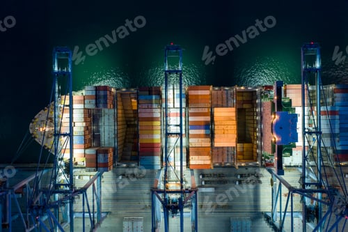 Preview: Aerial view At container terminal,crane lifts container from ship to truck to deliver goods