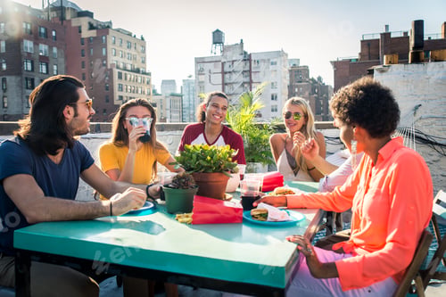 Preview: Group of friends having party on a rooftop