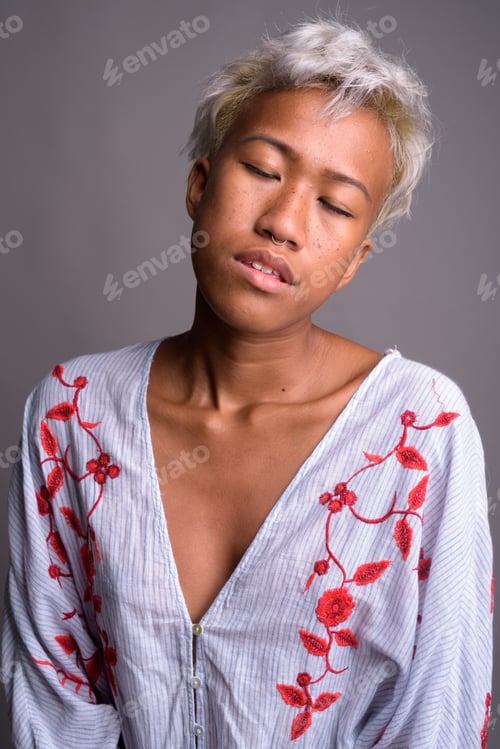 Preview: Young beautiful woman with short hair relaxing with eyes closed