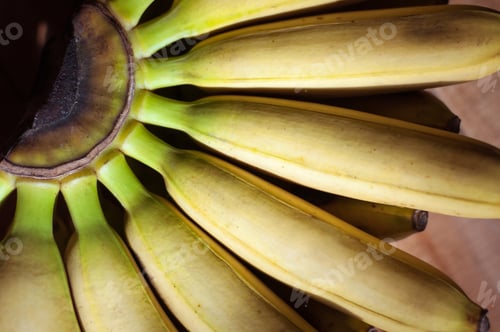 Preview: A bunch of yellow bananas on a wooden background