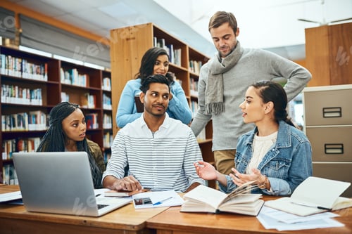 Preview: Cropped shot of a group of university students studying in the library