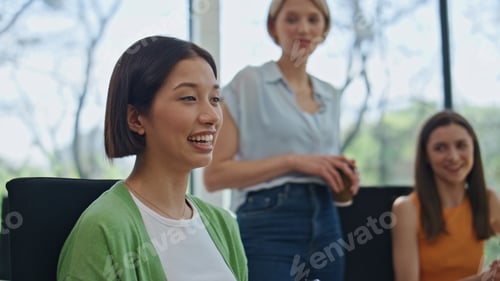 Preview: Happy colleagues laughing together in office closeup. Relaxed coworkers talking