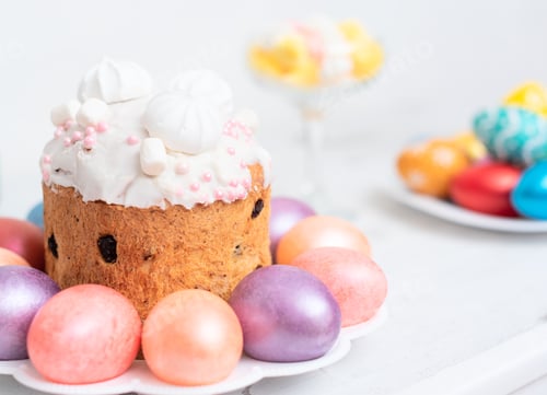 Preview: Easter cake and bright painted eggs on white background. Selective focus. Happy Easter concept.