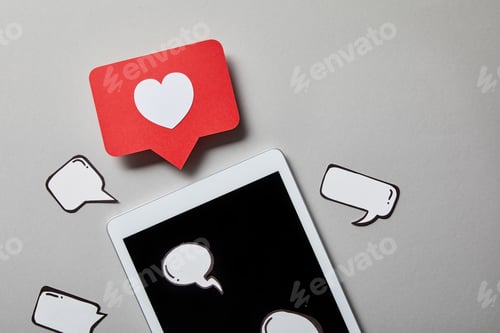 Preview: digital tablet with paper like sign, thought and speech bubbles on white surface