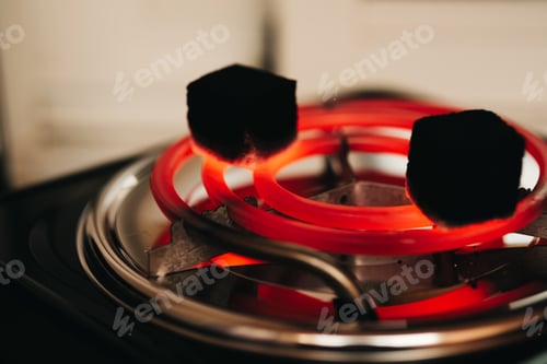 Aperçu: Coconut coals being heated for use in a hookah