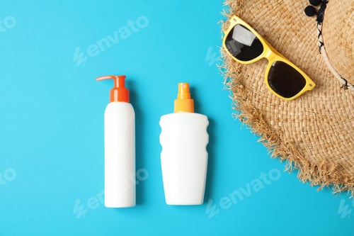 Preview: Flat lay composition with sun protection products on color background