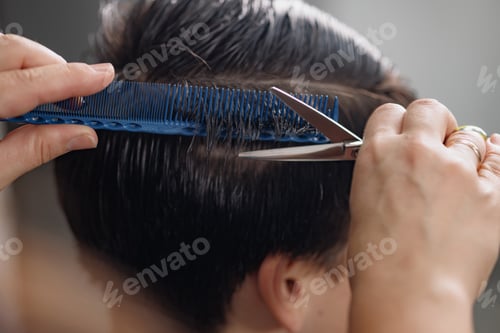 Preview: professional hairdresser cuts a guy's hair in a beauty salon, men's haircuts close-up
