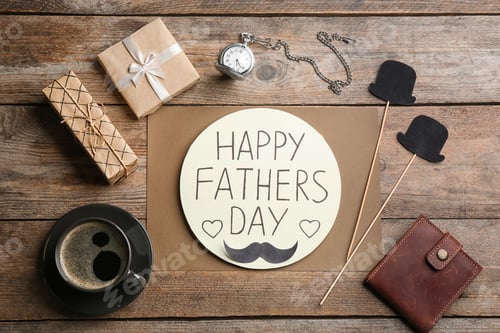 Preview: Greeting card with phrase HAPPY FATHER'S DAY, coffee and wallet on wooden table, flat lay