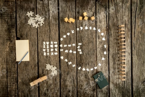 Preview: Puzzle Pieces Forming Lightbulb on Rustic Wooden Surface