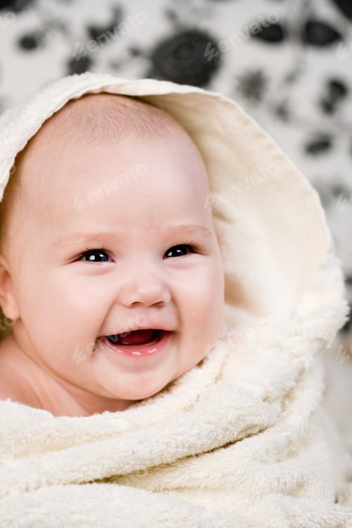 Preview: Smiling Infant Wrapped in a Fluffy White Towel