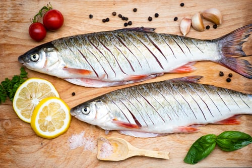 Preview: Fish with aromatic herbs, spices and vegetables - healthy food, diet or cooking concept