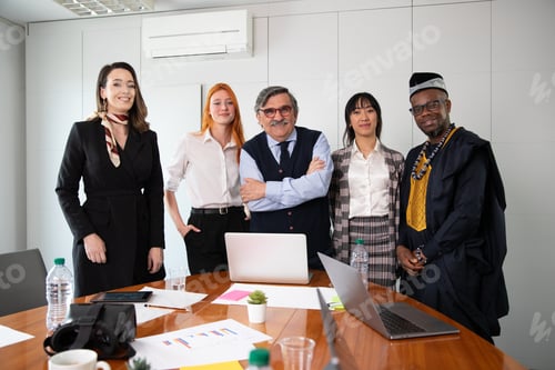 Preview: Group of business people pose together during a meeting, multi ethnic group