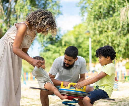 Preview: Latin family with two children, a baby and a boy playing in the park